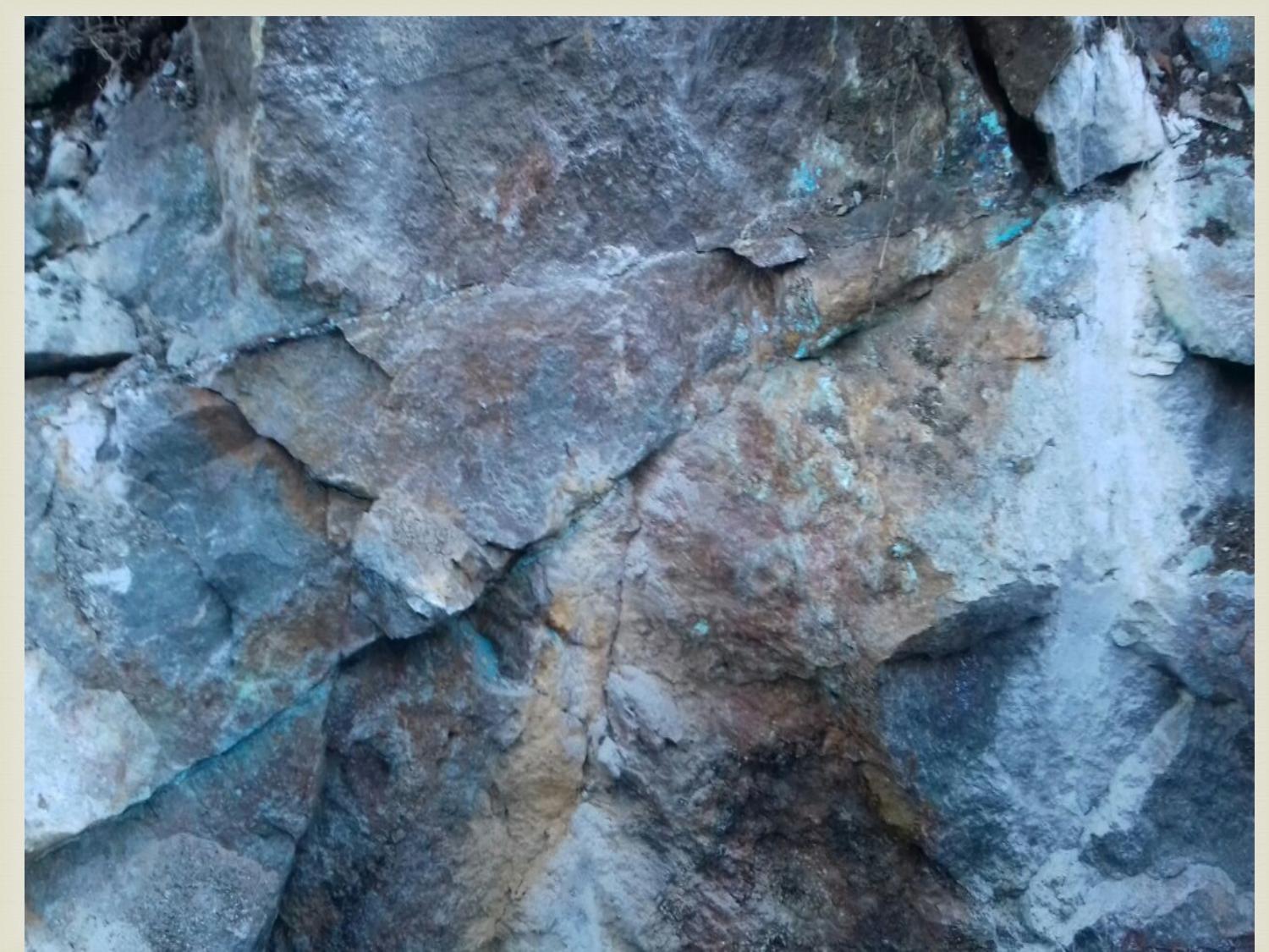 Outcrop with visible copper oxide staining in fracture zones